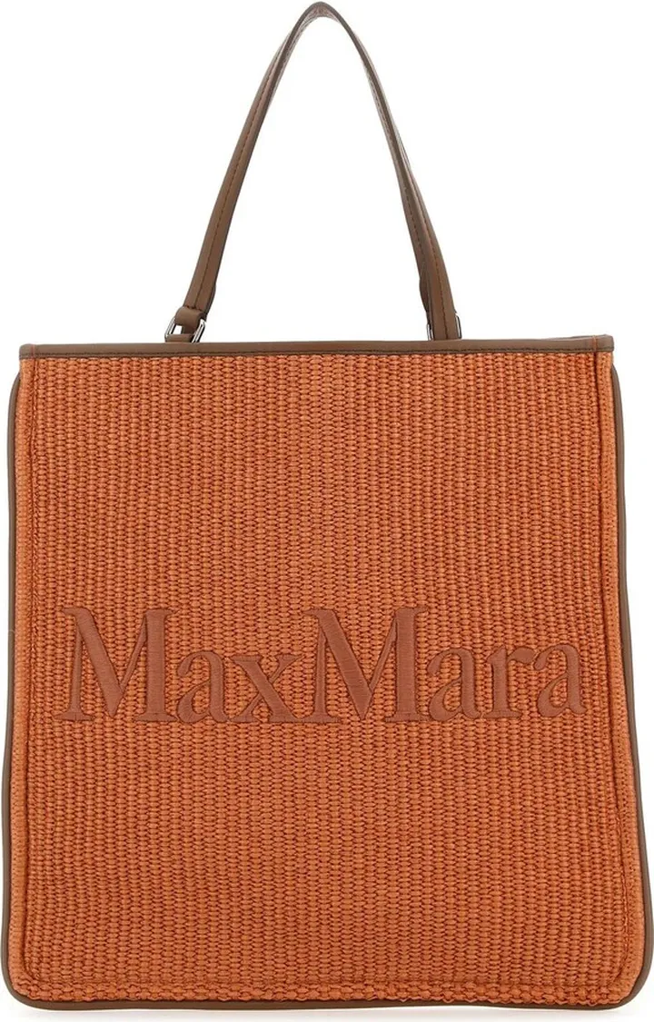 Shopping bag realized in raffia with leather trimming characterized by tonal embroidered logo at the front.
