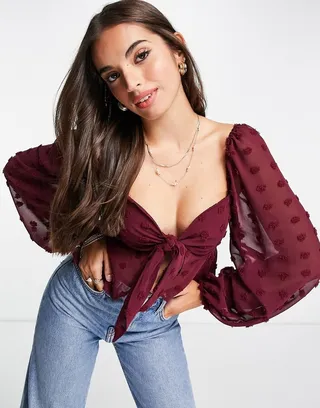 ASOS DESIGN textured sheer volume sleeve blouse with tie front detail in oxblood
