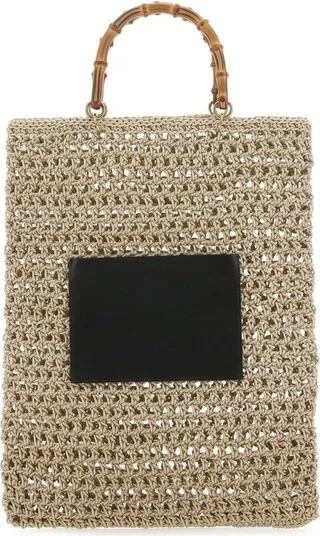 Shopping bag realized in rope enriched by a contrasting leather patch pocket at the front.