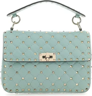 Handbag realized in lamb nappa leather enriched by metal studs on the entire surface.