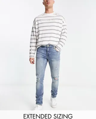 ASOS DESIGN skinny jean in mid wash with rips