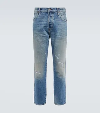 Distressed mid-rise tapered jeans