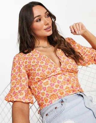 ASOS DESIGN button front tea blouse with volume sleeves and tie back detail in bright tile print