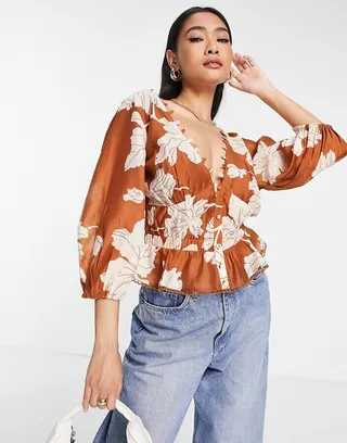 ASOS DESIGN elastic waist blouse with peplum hem & button detail in tonal floral