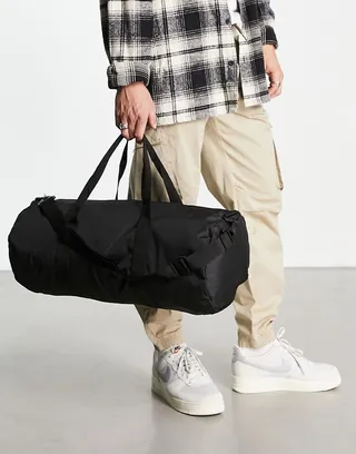 ASOS DESIGN weekend holdall barrel bag in black nylon with contrast puller
