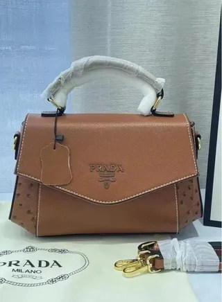 Prada handbag with a modern design and a long strap 