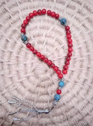 Rosary of 33 red beads with a silver pendant 