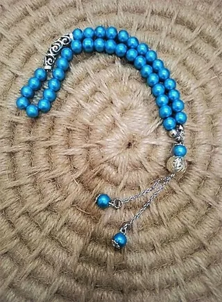 Car mirror hanger made of turquoise beads with a distinctive pendant 