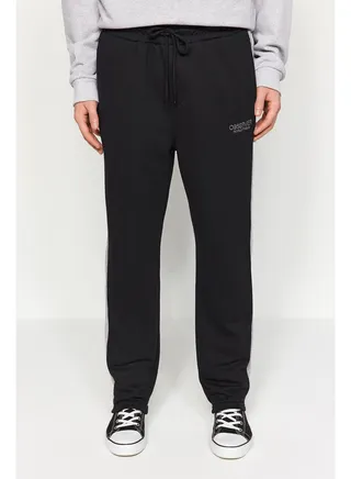 Black Men's Regular/Regular Cut Contrast Color Paneled Bold Text with Embroidered Regular Leg Sweatpants. 