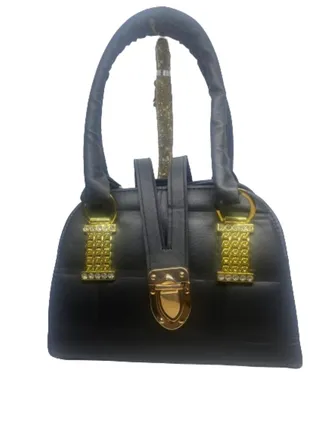 A luxurious black women's bag with a black leather handle 