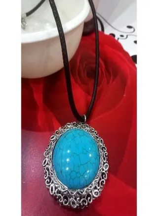 Chain with a luxurious turquoise pendant in the form of a pendulum or an obelisk 