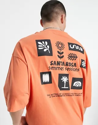 ASOS DESIGN oversized T-shirt in orange with cartoon front & back puff print