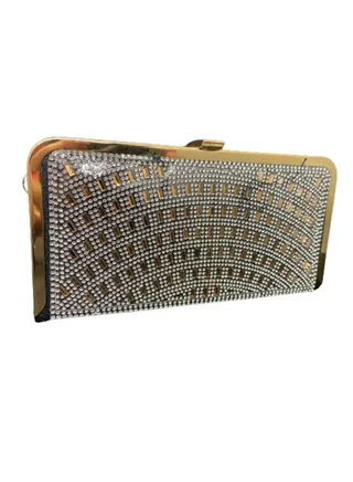 A luxurious women's bracelet bag, gold and black, decorated with a golden metal arm 