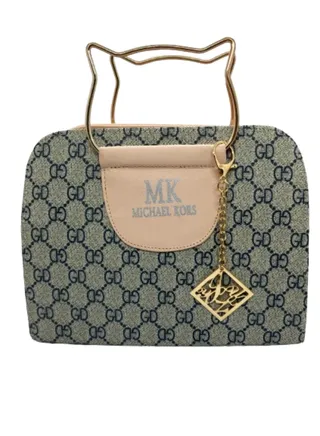 A luxurious women's handbag in pink color with a golden metal handle 