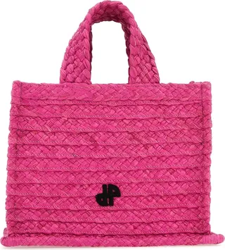 Handbag realized in woven straw enriched by JP patches at the front and at the back.