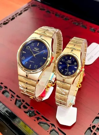 set of men's and women's watches with a gold strap, a blue dial, and English numbers, with a box 