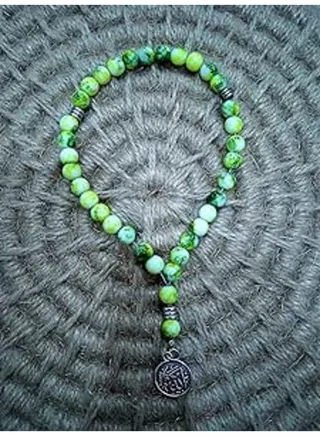 Green rosary decorated with a religious pendant 