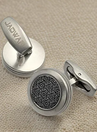 A silver cufflink holder embossed in black, characterized by its elegant and modern design, a wonderful touch of elegance to your look 