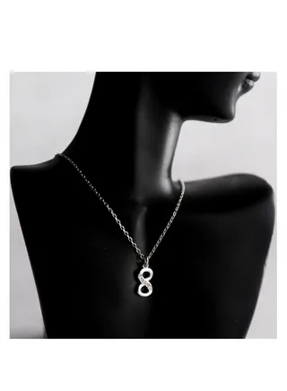 A unique silver women's chain with a pendant design containing the number 8 