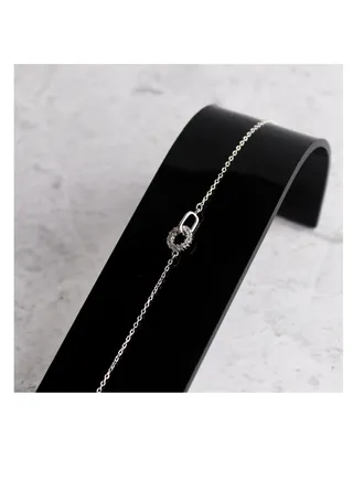 A unique silver women's bracelet with a circular pendant design 