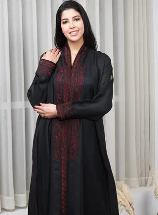 Black abaya with red thread embroidery on the sleeves and collar and a pattern on the back 