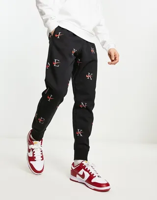 Nike Club Fleece all over print sweatpants in black