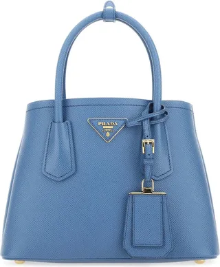 Handbag realized in Saffiano leather enriched by iconic logoed triangle at the front and detachable tonal leather accessory.