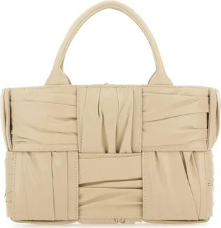 Handbag realized in pleated calf leather characterized by iconic Intrecciato motif on the entire surface.