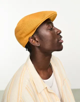 ASOS DESIGN knit flat cap in burnt orange