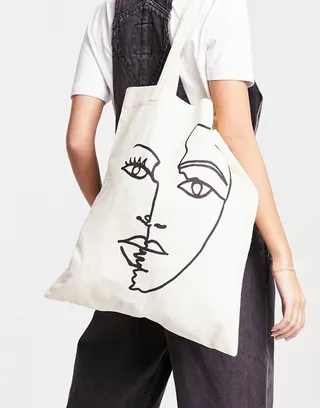 ASOS DESIGN cotton tote bag with placement abstract face print