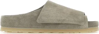 Slippers created in collaboration with Fear Of God realized in suede characterized by embossed logo on the side and adjustable velcro band.