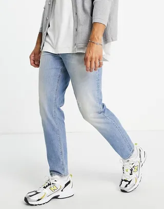ASOS DESIGN tapered jeans in light wash with abrasions