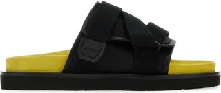 Slippers realized in smooth leather and nylon.