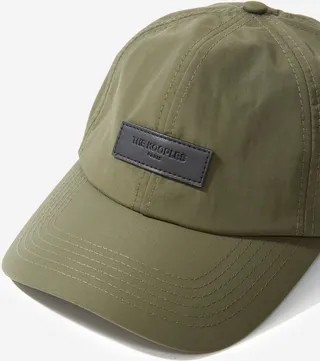 Khaki nylon cap with black leather badge