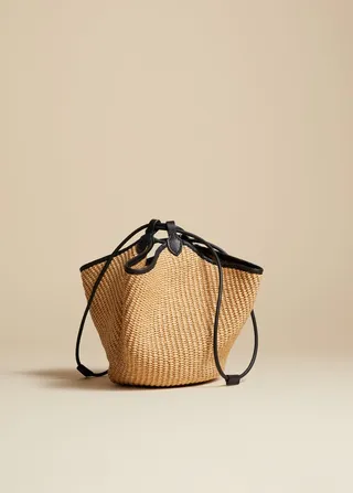 The Mini Lotus Drawstring Bag in Natural Raffia and Black Leather