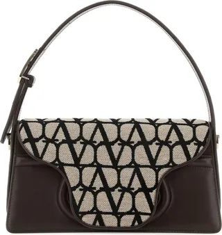 Shoulder bag realized in Toile Iconographe and slightly pebble leather enriched by metal Vlogo detail on the handle.