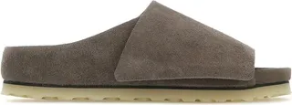 Slippers created in collaboration with Fear Of God realized in suede characterized by embossed logo on the side and adjustable velcro band.