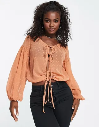 ASOS DESIGN textured blouse with volume long sleeve with tie front in orange