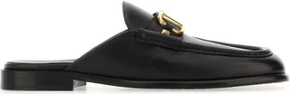Nero Black Leather Vlogo Slippers from Valentino Garavani Slippers realized in slightly pebble leather enriched by metal Vlogo detail on the instep.