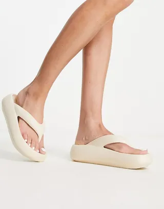 Truffle Collection molded flip flops in cream