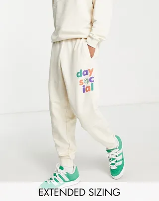 ASOS Daysocial relaxed sweatpants with multi logo prints and seam detailing in ecru - part of a set