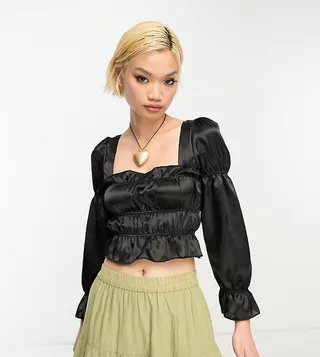 Reclaimed Vintage long sleeve satin ruffle top with tie back in black