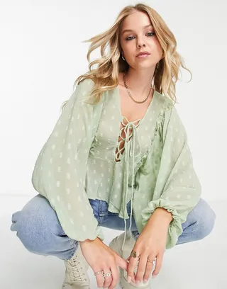 ASOS DESIGN textured long sleeve blouse with lace up front & peplum hem in sage