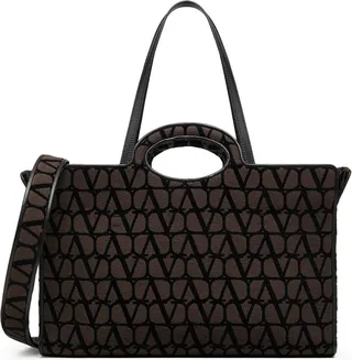 Valentino Garavani Le Troisième shopping bag in Toile Iconographe. The bag features shaped handles and can be used as a hand or shoulder bag thanks to the removable shoulder strap and the double leather handles.