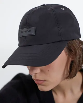 Black nylon cap with matching leather badge