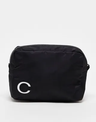 ASOS DESIGN toiletries bag with C initial in black