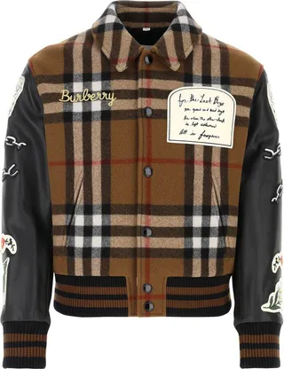 Bomber jacket realized in tech wool with calf leather sleeves characterized by tartan motif embroidery on the entire surface enriched by logoed patches.