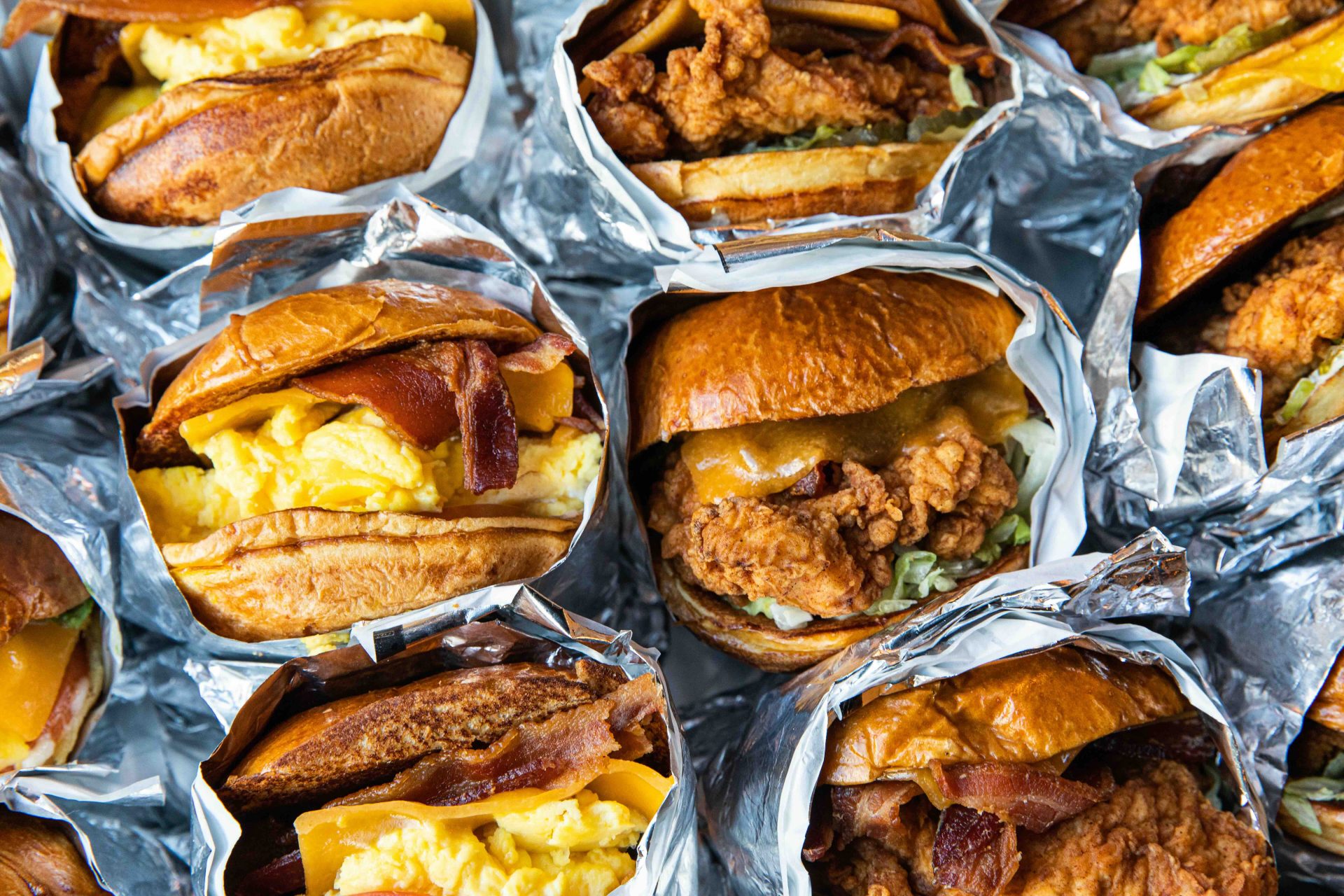 Catering pack of breakfast and chicken sandwiches in a pan.