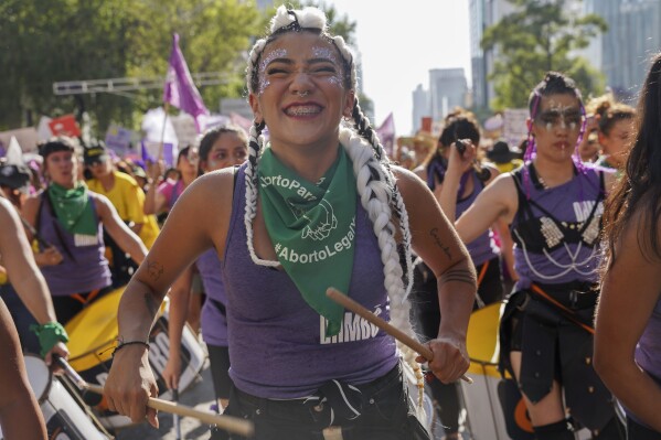 Facing historic shifts, Latin American women bathe streets in purple on International Women’s Day