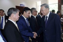 President To Lam meets Vietnamese people in Laos